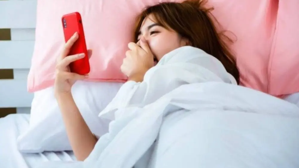 5 thói quen buổi sáng cần điều chỉnh để bảo vệ tim, trong đó có việc cầm điện thoại ngay khi vừa thức dậy.